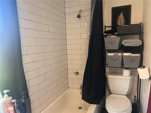a bathroom with a toilet and a shower