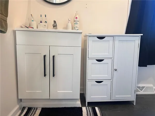 a bathroom with a mirror and a shower