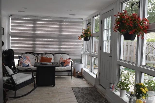 a living room with furniture and a potted plant