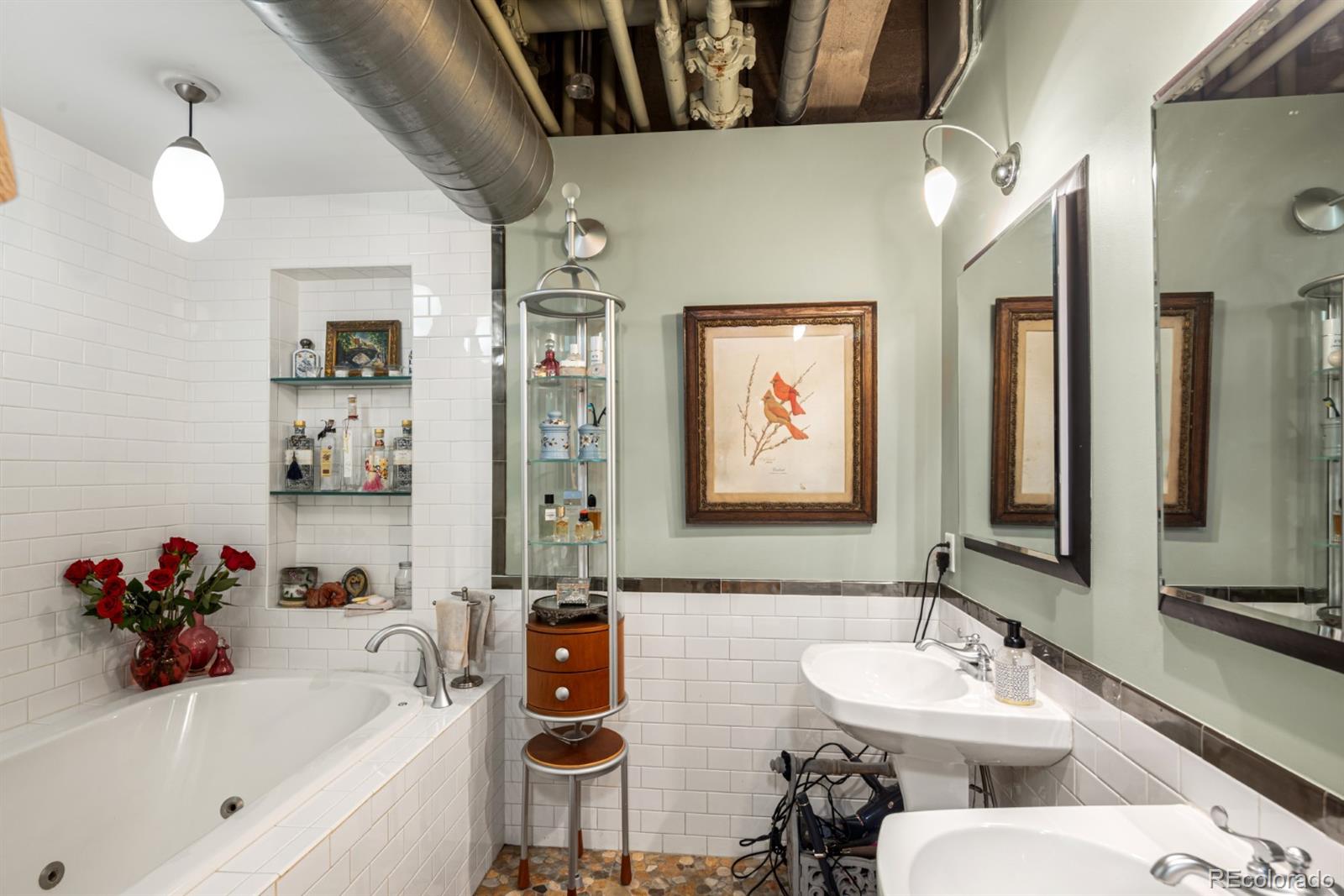 2000 Little Raven Street, Unit 1B Denver, CO 80202 - Photo 22 of 39 a bathroom with a sink mirror and a bathtub