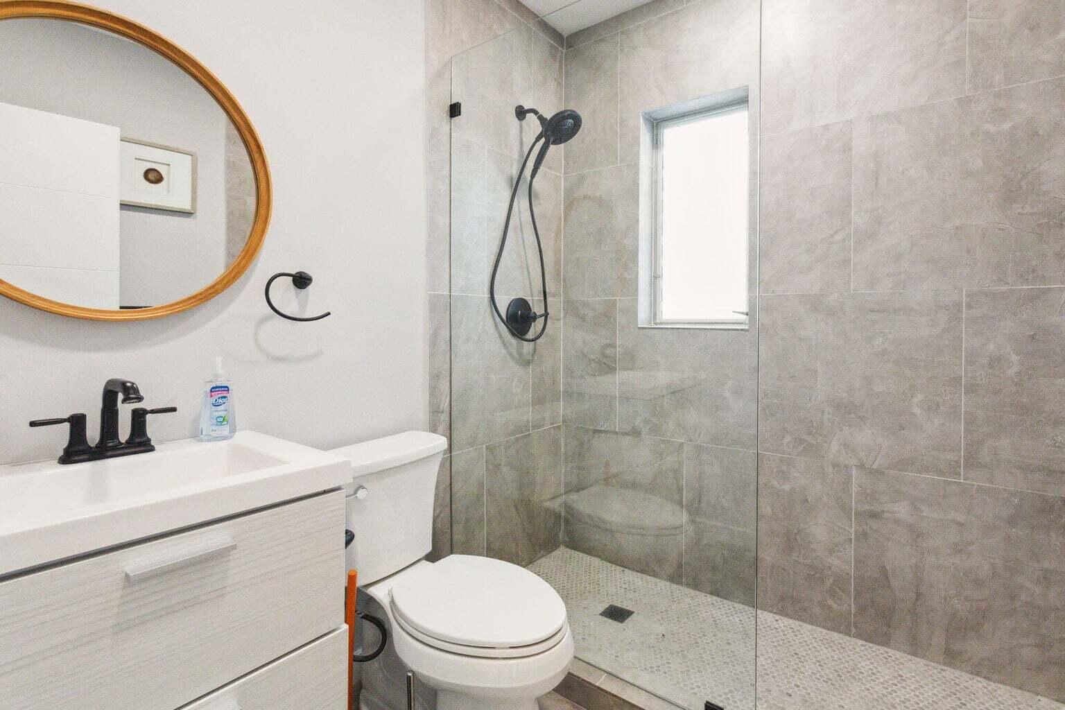 711 Southeast 2nd Street, Unit 4 Delray Beach, FL 33483 - Photo 15 of 23 a bathroom with a sink a toilet and shower