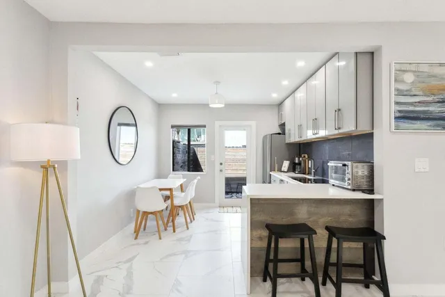 a kitchen with stainless steel appliances granite countertop a refrigerator sink and cabinets