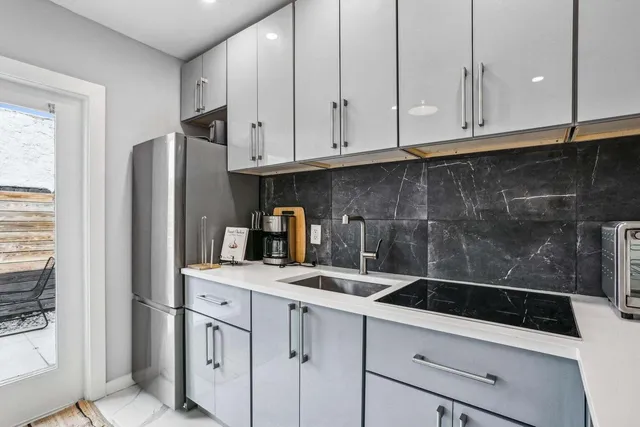 a kitchen with a sink dishwasher stove and cabinets