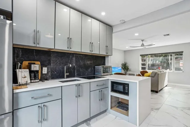 a living room with furniture a mirror a piano and a table