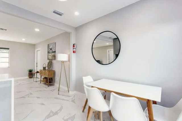 a living room with furniture a rug and a window