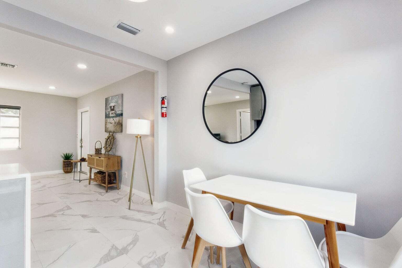 711 Southeast 2nd Street, Unit 4 Delray Beach, FL 33483 - Photo 8 of 23 a living room with furniture a mirror a piano and a table