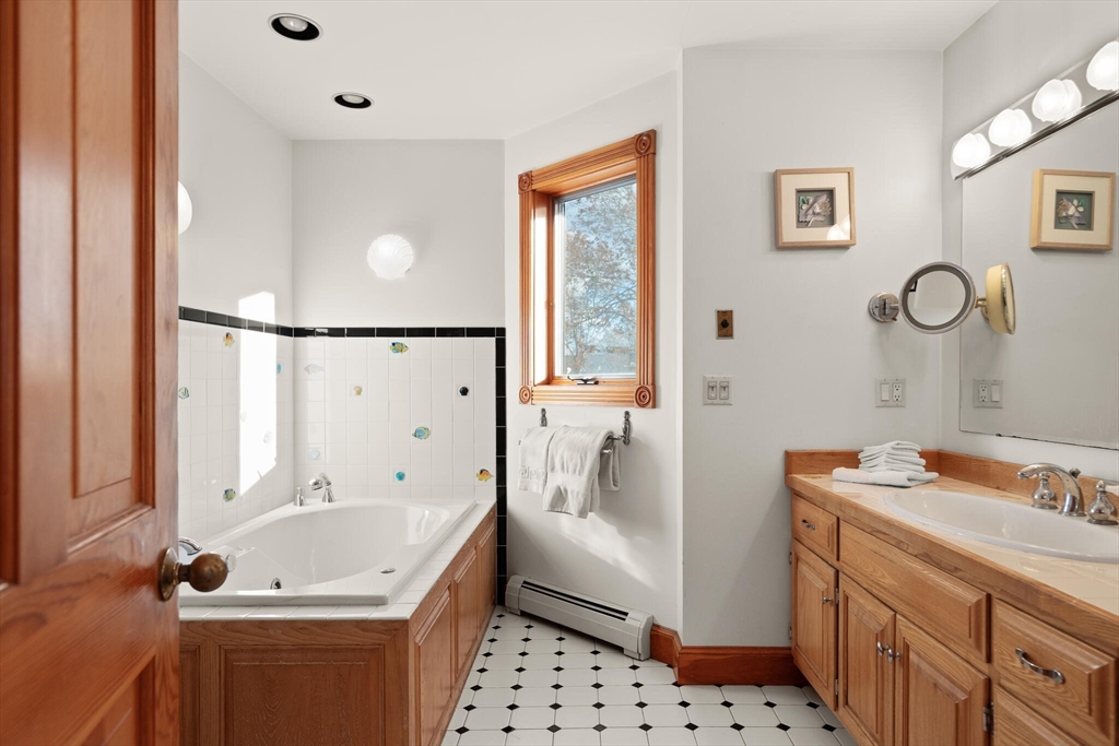 20 Calder Street Gloucester, MA 01930 - Photo 17 of 27 a bathroom with a sink a mirror and a bathtub