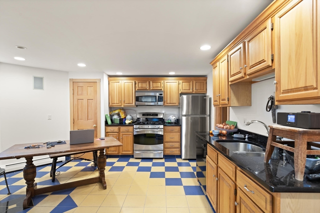 20 Calder Street Gloucester, MA 01930 - Photo 22 of 27 a kitchen with refrigerator and chairs