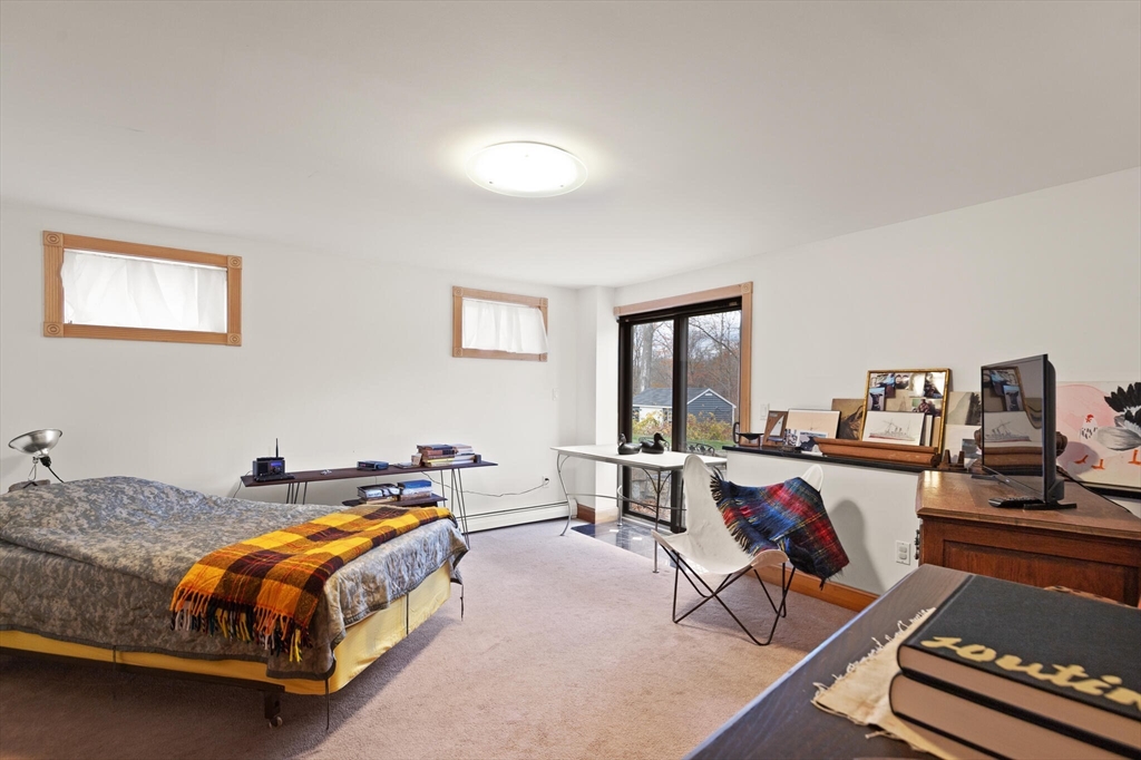 20 Calder Street Gloucester, MA 01930 - Photo 23 of 27 a spacious bedroom with a bed and a desk