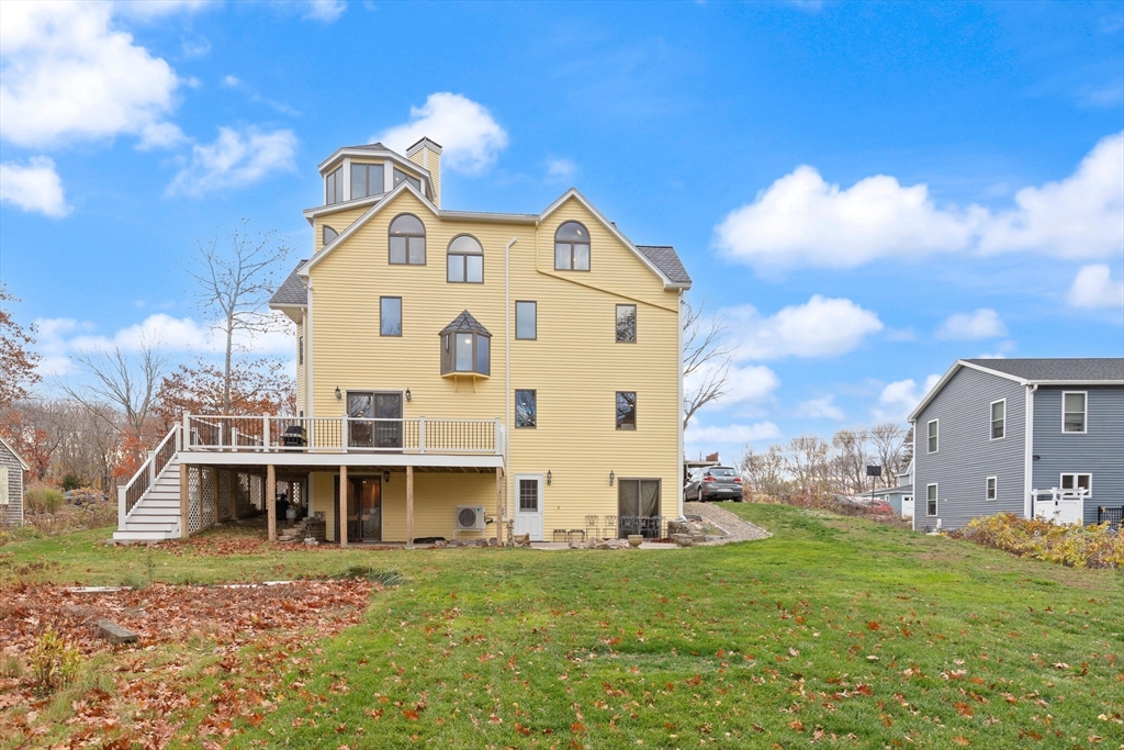 20 Calder Street Gloucester, MA 01930 - Photo 26 of 27 a view of a large white building with a big yard
