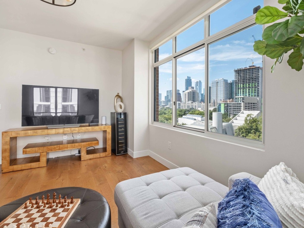54 Rainey Street, Unit 918 Austin, TX 78701 - Photo 1 of 40 a bedroom with furniture and a window