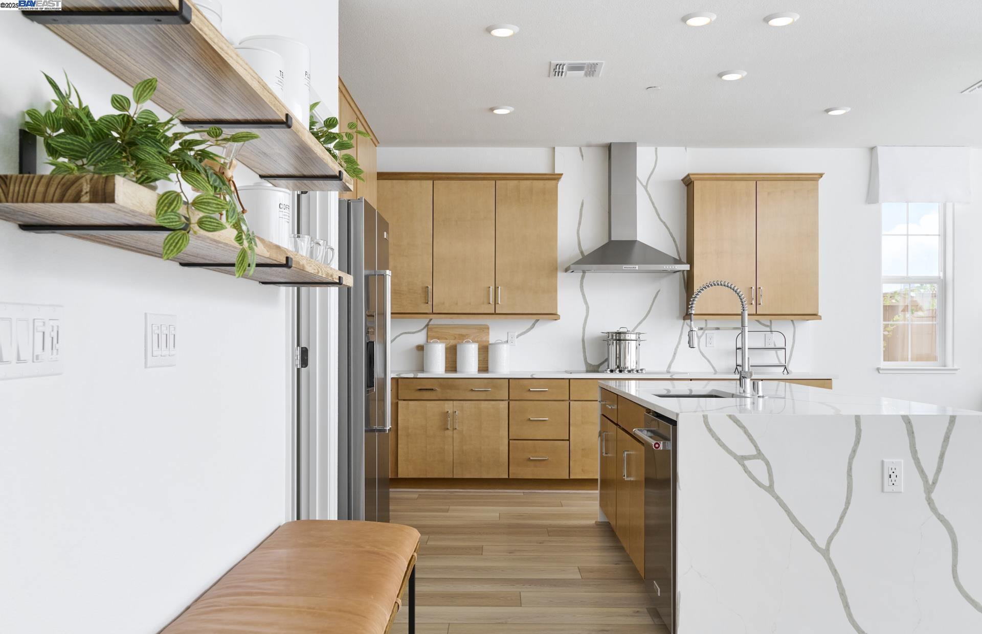 a kitchen with stainless steel appliances granite countertop a sink a stove and a refrigerator