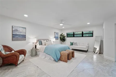 a spacious bedroom with a bed and couch