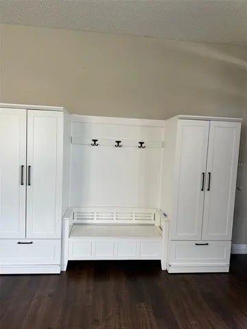 a view of walk in closet with wooden floor