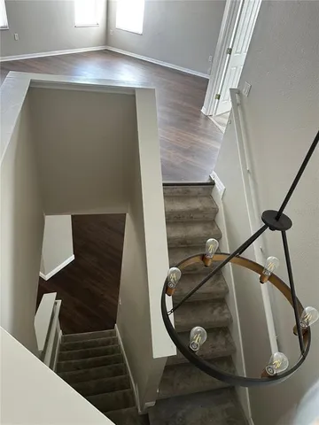 a bathroom with a granite countertop sink a toilet and a mirror