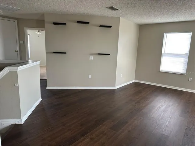 a kitchen with stainless steel appliances kitchen island granite countertop a table chairs sink and cabinets