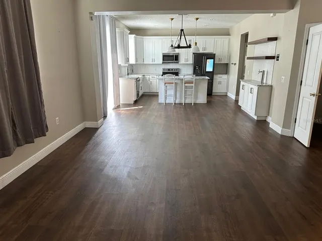 an empty room with wooden floor and closet