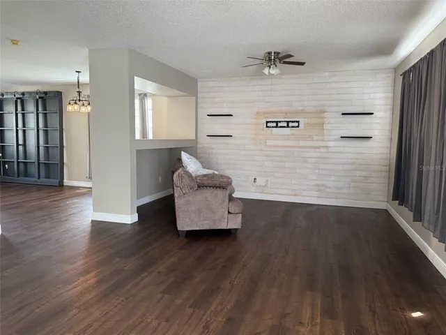 a view of an empty room and wooden floor