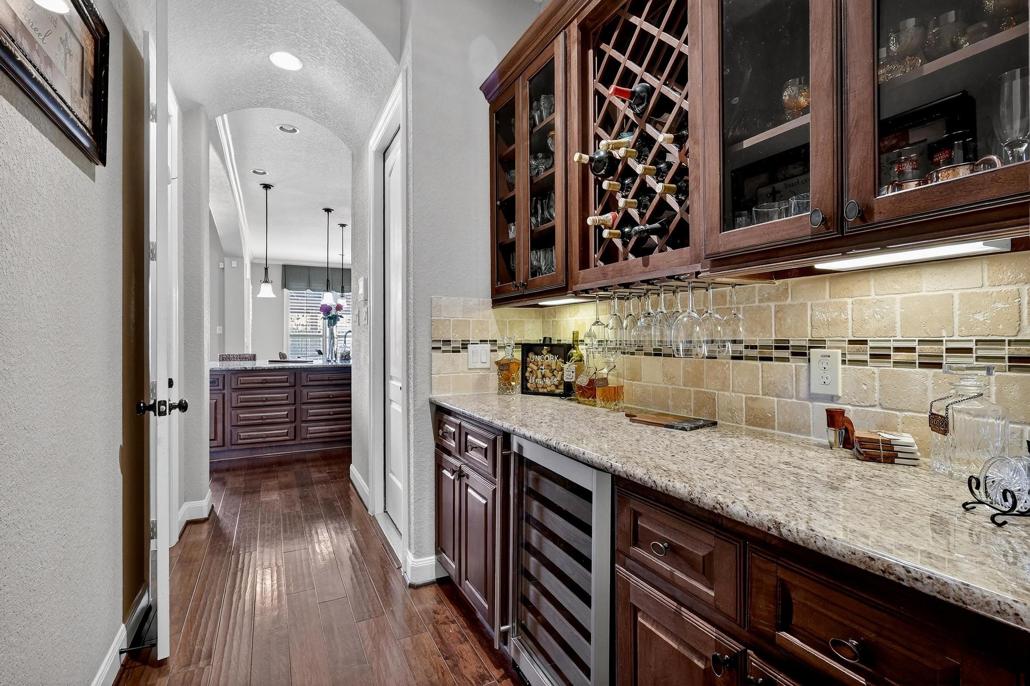 25803 Heritage Maple Drive Spring, TX 77389 - Photo 8 of 46 a kitchen with counter top space and wooden floor