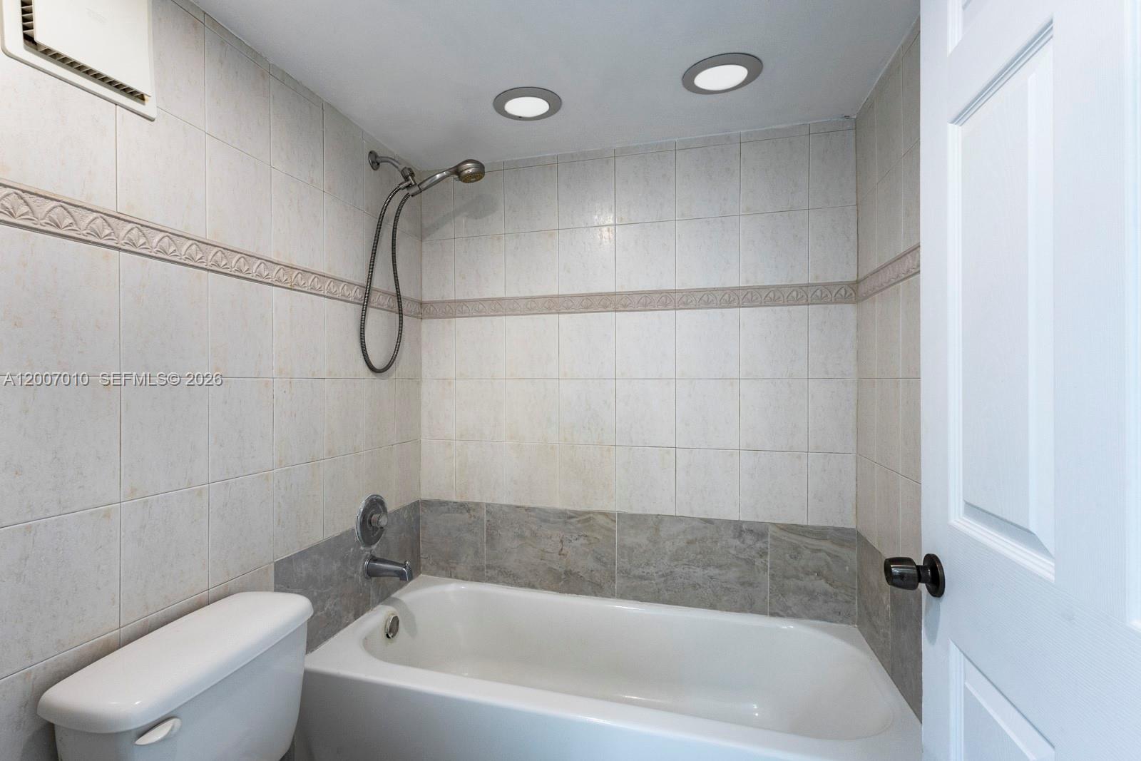 10855 Southwest 112th Avenue, Unit 211 Miami, FL 33176 - Photo 6 of 23 a bathroom with a bath tub with a shower