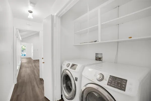 a view of washer and dryer with kitchen in the background