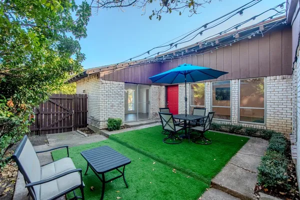 a view of a house with backyard sitting area and garden