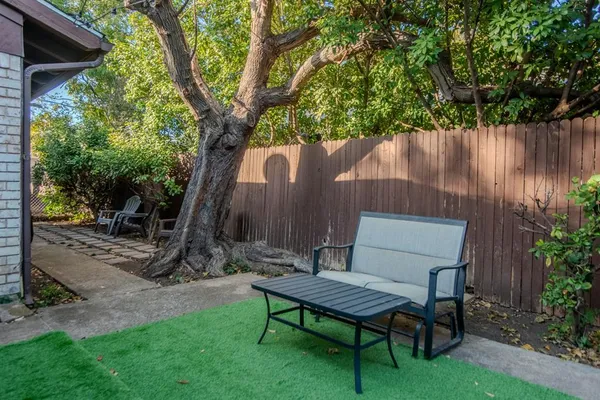 a backyard of a house with table and chairs
