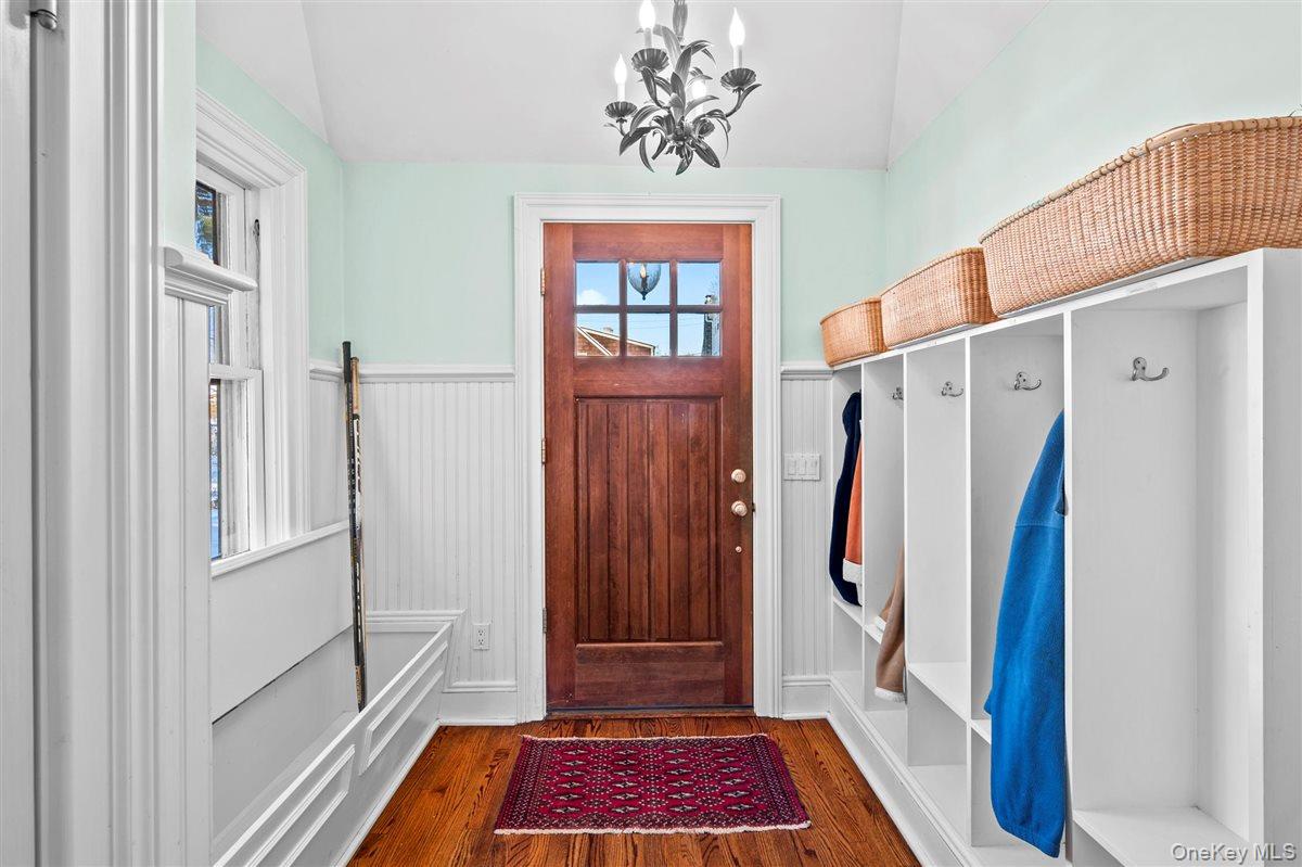 525 Milton Road Rye, NY 10580 - Photo 15 of 31 Mudroom with a wainscoted wall, wood finished floors, and a chandelier