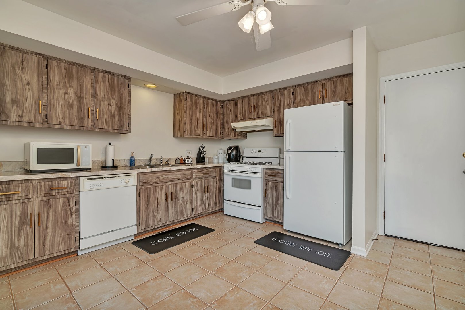 403 South Raven Road Shorewood, IL 60404 - Photo 11 of 24 a kitchen with cabinets and white appliances