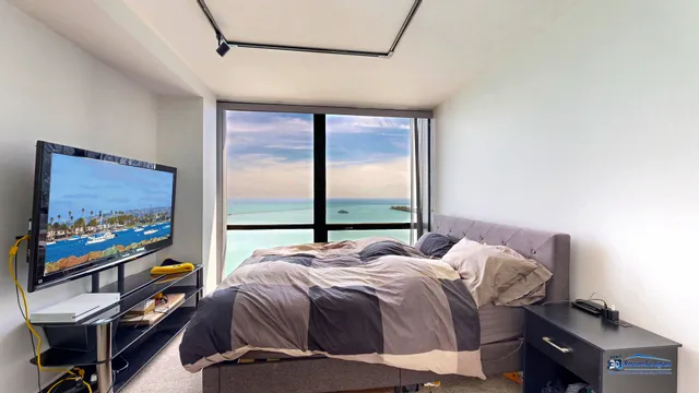 a bedroom with furniture and a flat screen tv