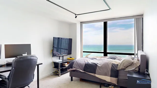 a bedroom with a bed window and lamp