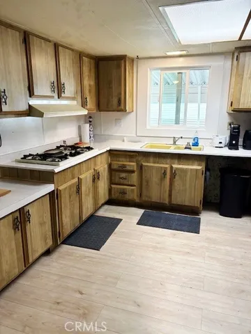 a kitchen with stainless steel appliances granite countertop a stove a sink dishwasher and a refrigerator