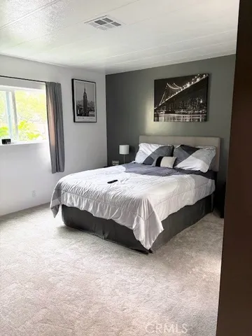 a bedroom with a bed and dresser