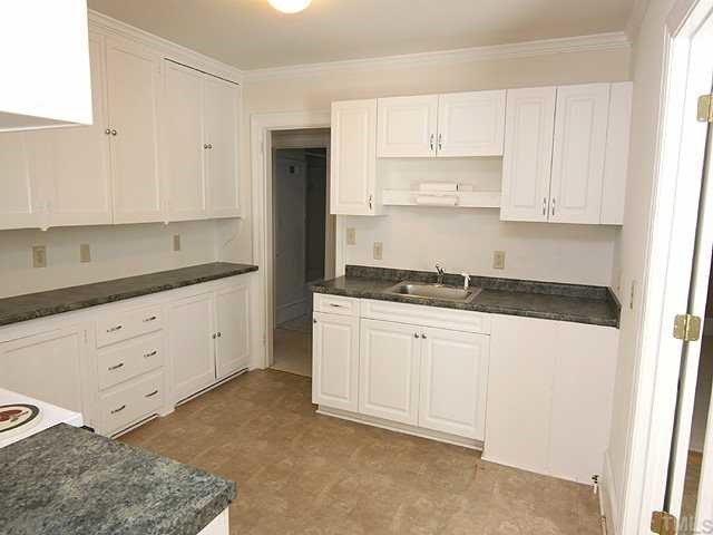 1508 Fairview Road Raleigh, NC 27608 - Photo 4 of 12 a kitchen with granite countertop white cabinets and stainless steel appliances