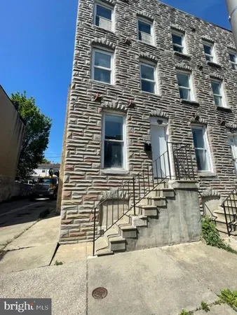 a view of a brick house with many windows