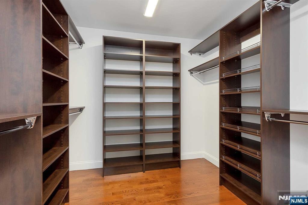 582 Green Valley Road Paramus, NJ 07652 - Photo 14 of 25 a view of walk in closet with clothes and shoes