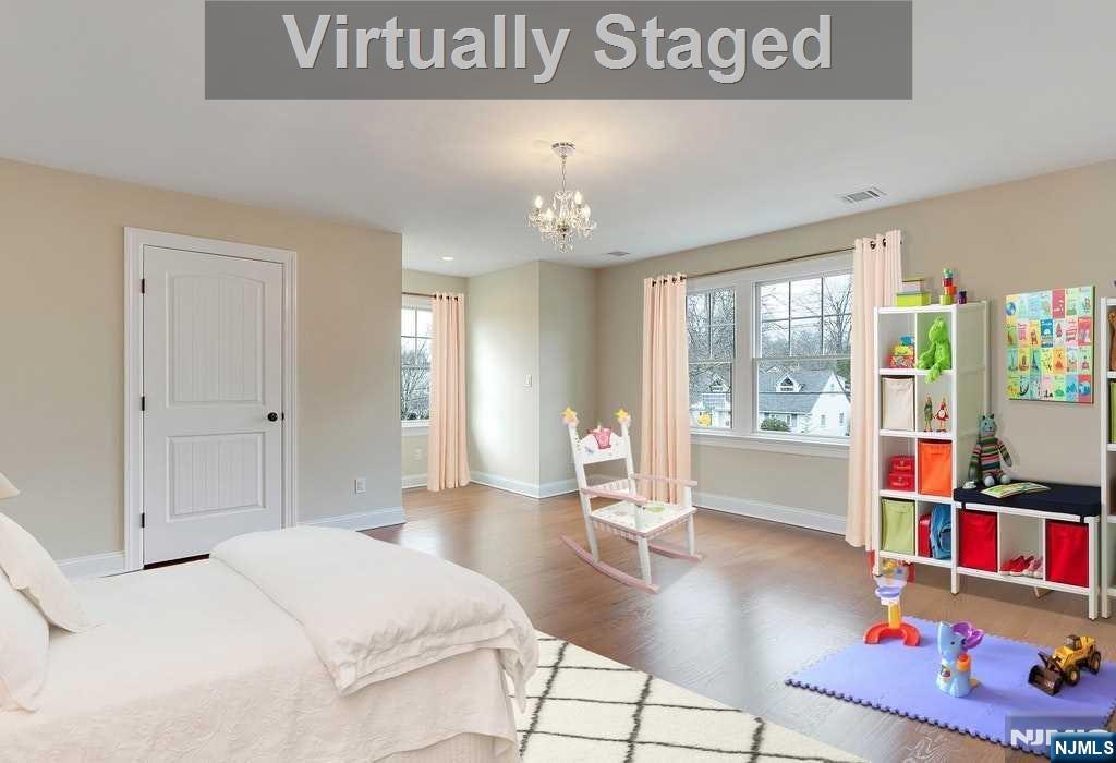 582 Green Valley Road Paramus, NJ 07652 - Photo 19 of 25 a bedroom with furniture and a book shelf