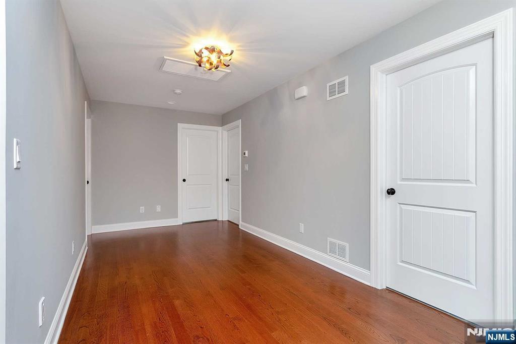 582 Green Valley Road Paramus, NJ 07652 - Photo 20 of 25 wooden floor in an empty room with a window