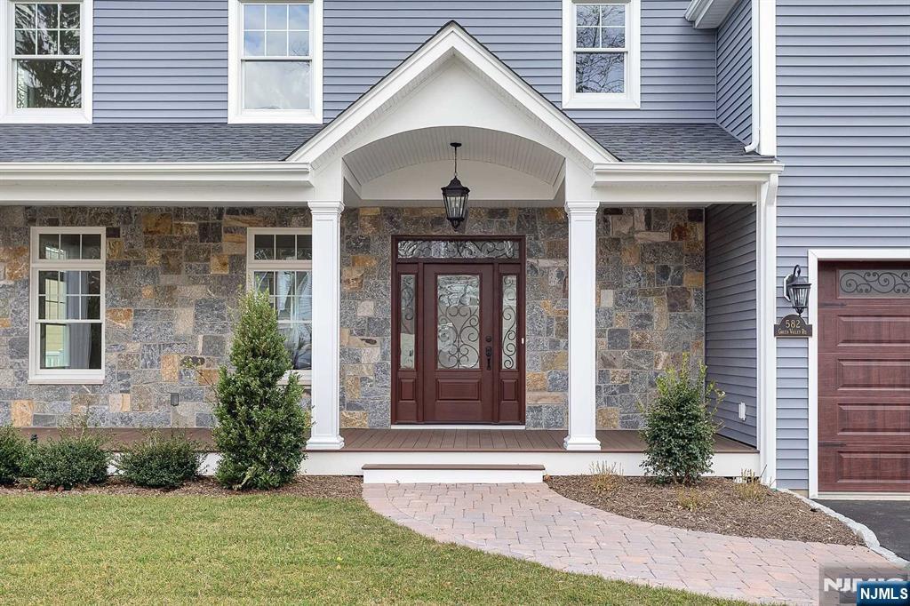 582 Green Valley Road Paramus, NJ 07652 - Photo 2 of 25 a front view of a house with garden