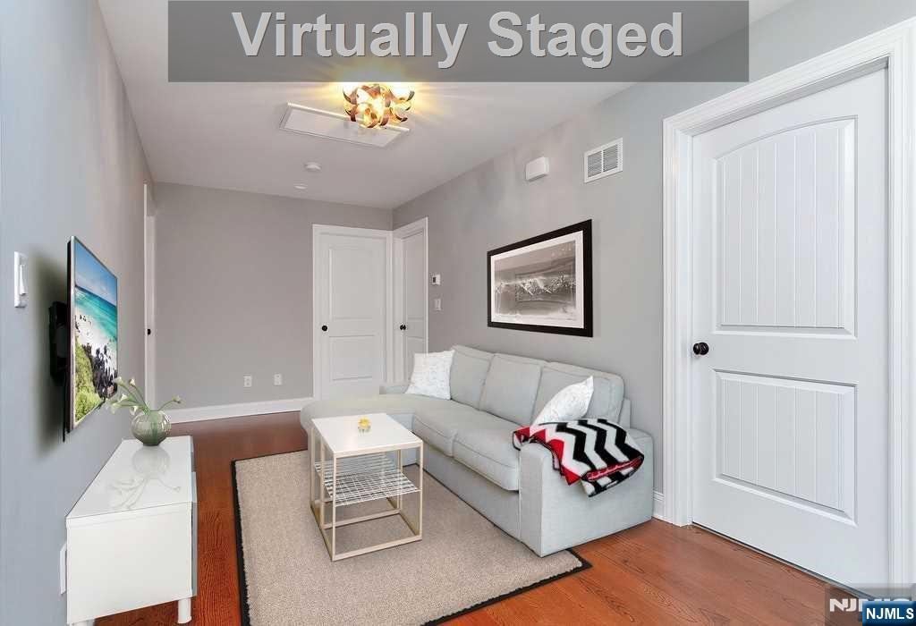 582 Green Valley Road Paramus, NJ 07652 - Photo 21 of 25 a living room with furniture and a flat screen tv