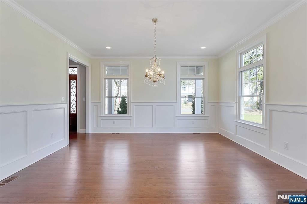 582 Green Valley Road Paramus, NJ 07652 - Photo 4 of 25 an empty room with wooden floor and windows