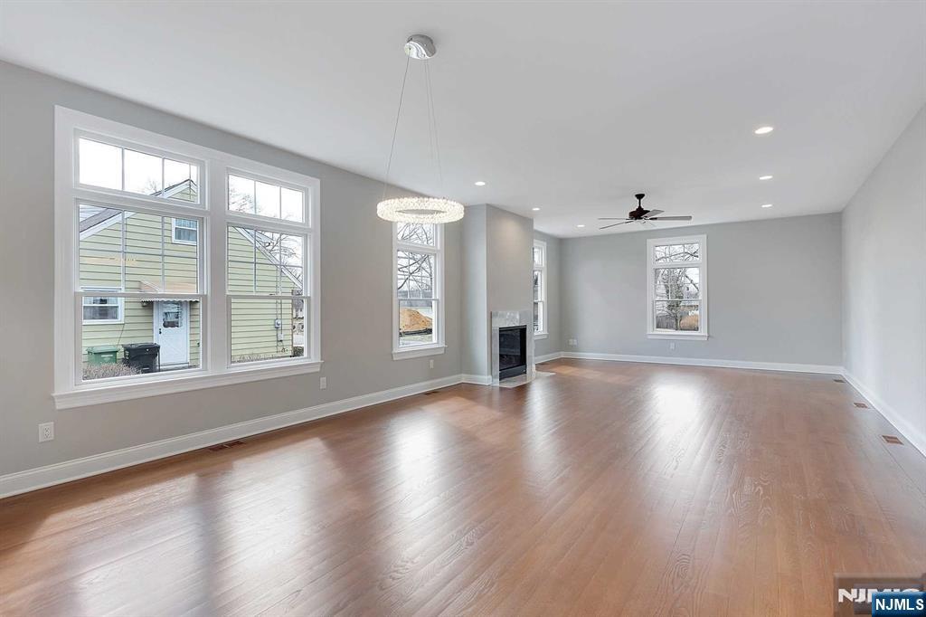 582 Green Valley Road Paramus, NJ 07652 - Photo 8 of 25 a view of an empty room with wooden floor and a window