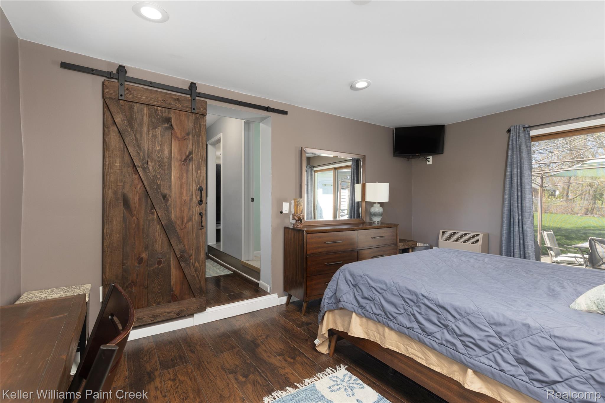 310 Elmhill Road Rochester, MI 48306 - Photo 21 of 37 Bedroom with a barn door, dark wood-style flooring, multiple windows, and recessed lighting
