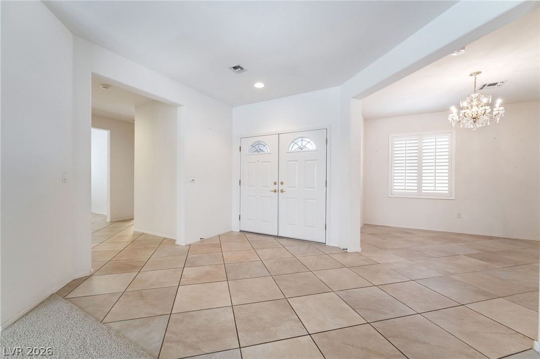3033 Hartsville Road Henderson, NV 89052 - Photo 7 of 41 A spacious foyer with tile flooring and a grand entry door awaits.
