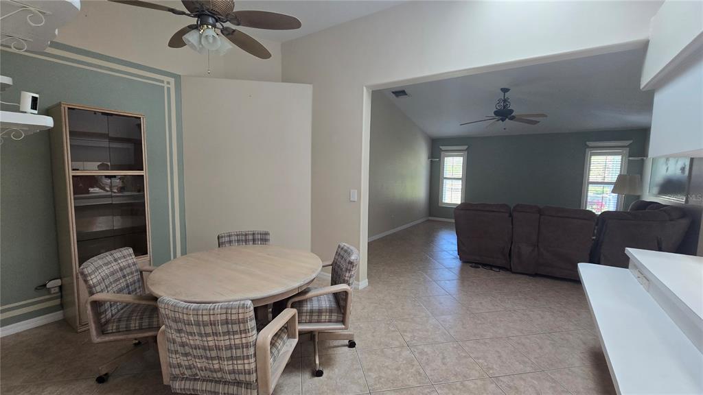 6501 Borg Street Leesburg, FL 34748 - Photo 17 of 59 a living room with furniture a dining table and chairs