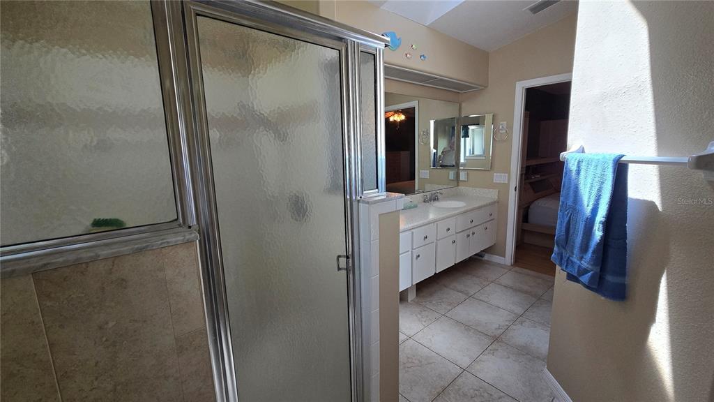 6501 Borg Street Leesburg, FL 34748 - Photo 25 of 59 a bathroom with a double vanity sink and mirror