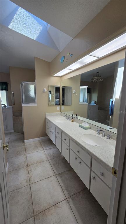 6501 Borg Street Leesburg, FL 34748 - Photo 28 of 59 a spacious bathroom with a granite countertop sink mirror and bathtub