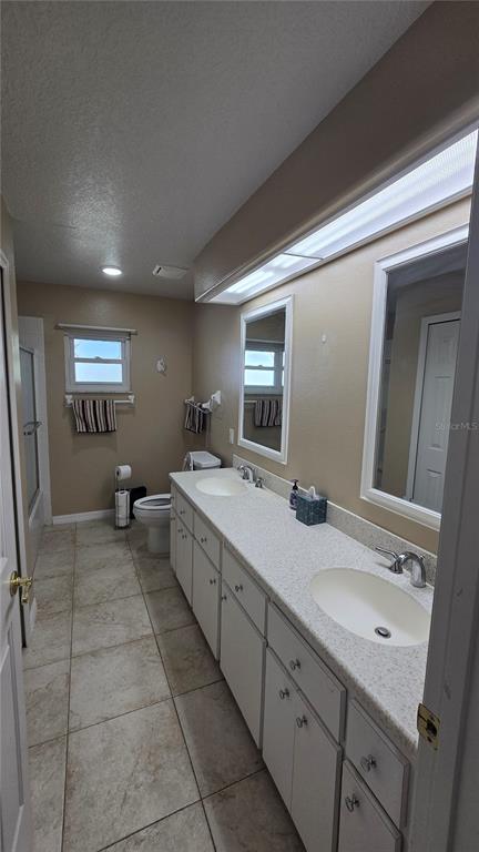 6501 Borg Street Leesburg, FL 34748 - Photo 38 of 59 a bathroom with a double vanity sink and a mirror