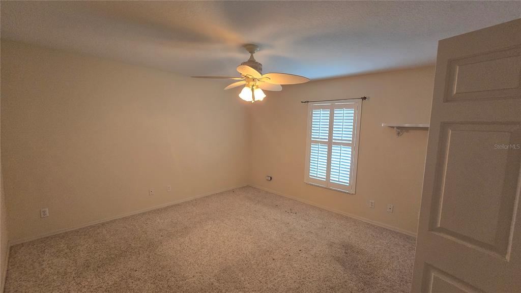 6501 Borg Street Leesburg, FL 34748 - Photo 39 of 59 a view of an empty room with window and chandelier fan