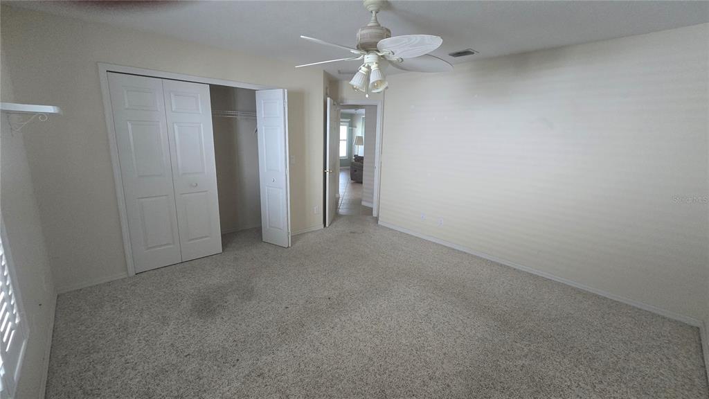6501 Borg Street Leesburg, FL 34748 - Photo 40 of 59 an empty room with a chandelier fan and closet